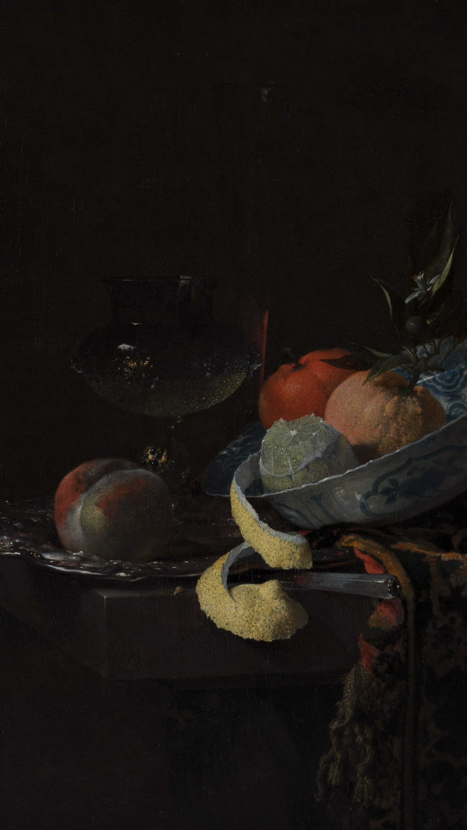 Dark academia vertical iPhone background from a painting: a blue-and-white Ming porcelain bowl of fruit beside a tall wine glass, a lemon peeled in one long spiral hanging over the table's edge