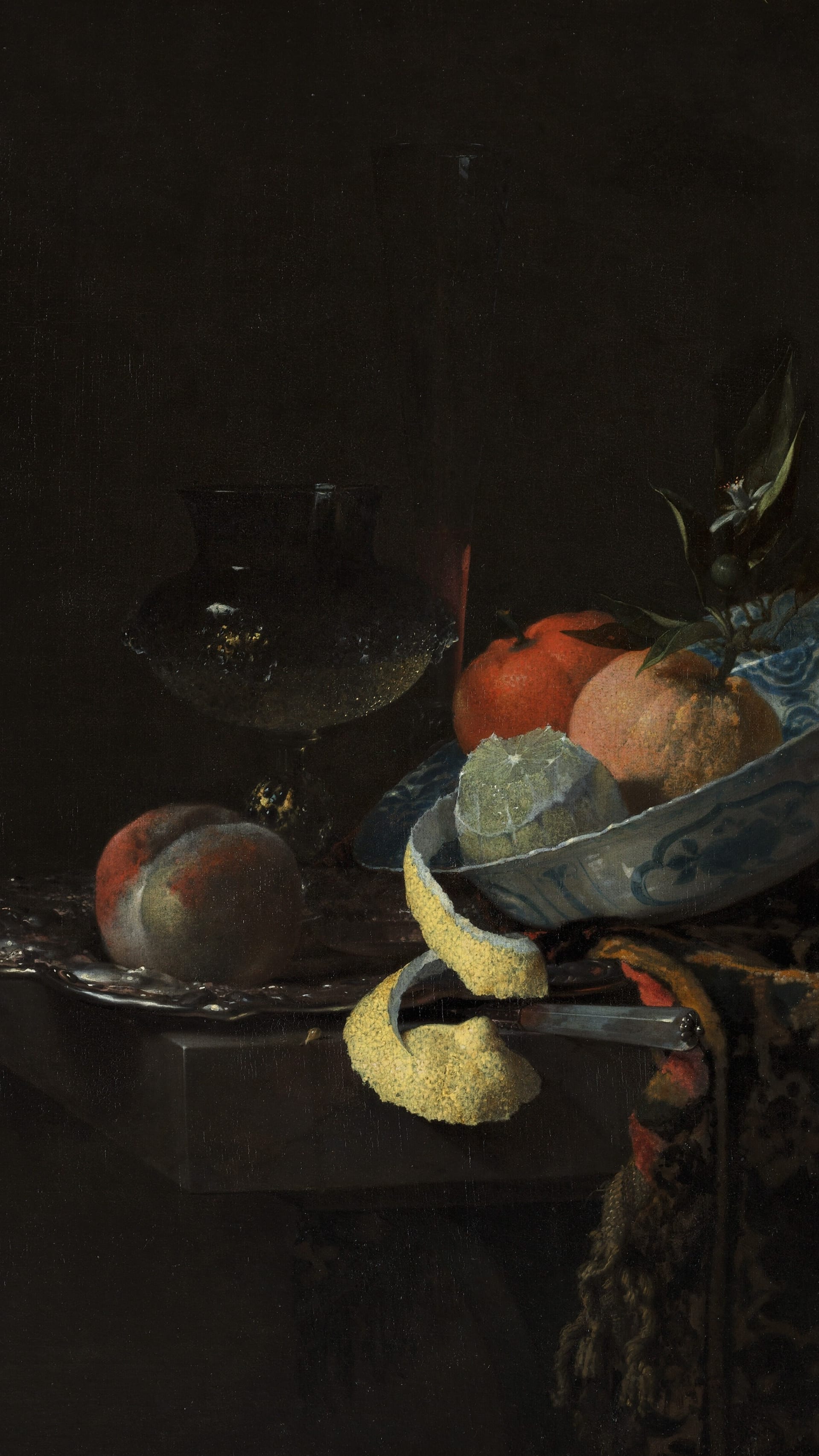 Dark academia vertical iPhone background from a painting: a blue-and-white Ming porcelain bowl of fruit beside a tall wine glass, a lemon peeled in one long spiral hanging over the table's edge