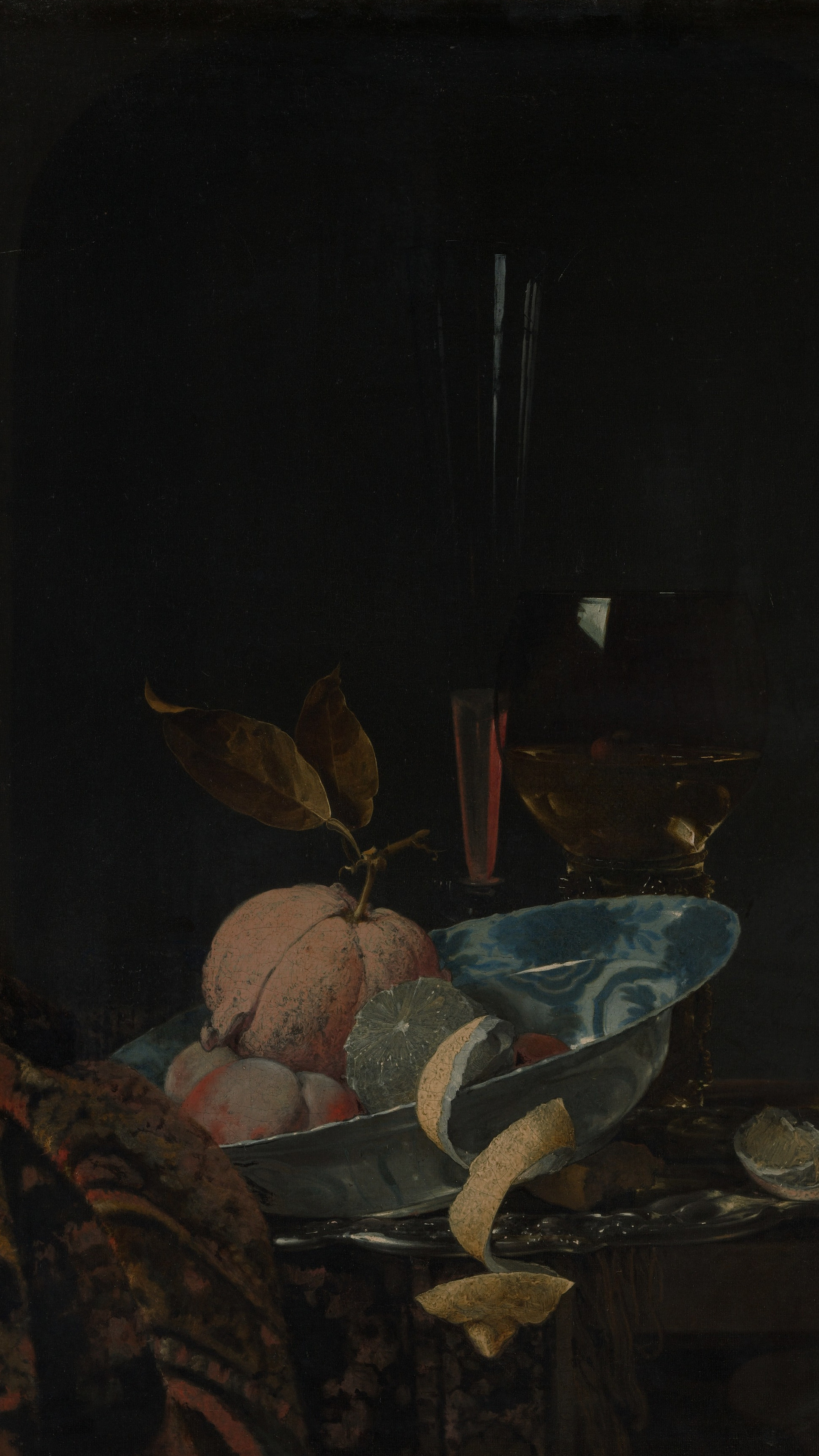 Dark academia vertical iPhone background from a painting: a blue-and-white Wanli porcelain bowl heaped with peaches and a pomegranate, a glass of rose-colored wine and a tall flute glass beside it, dark leaves trailing at the edge