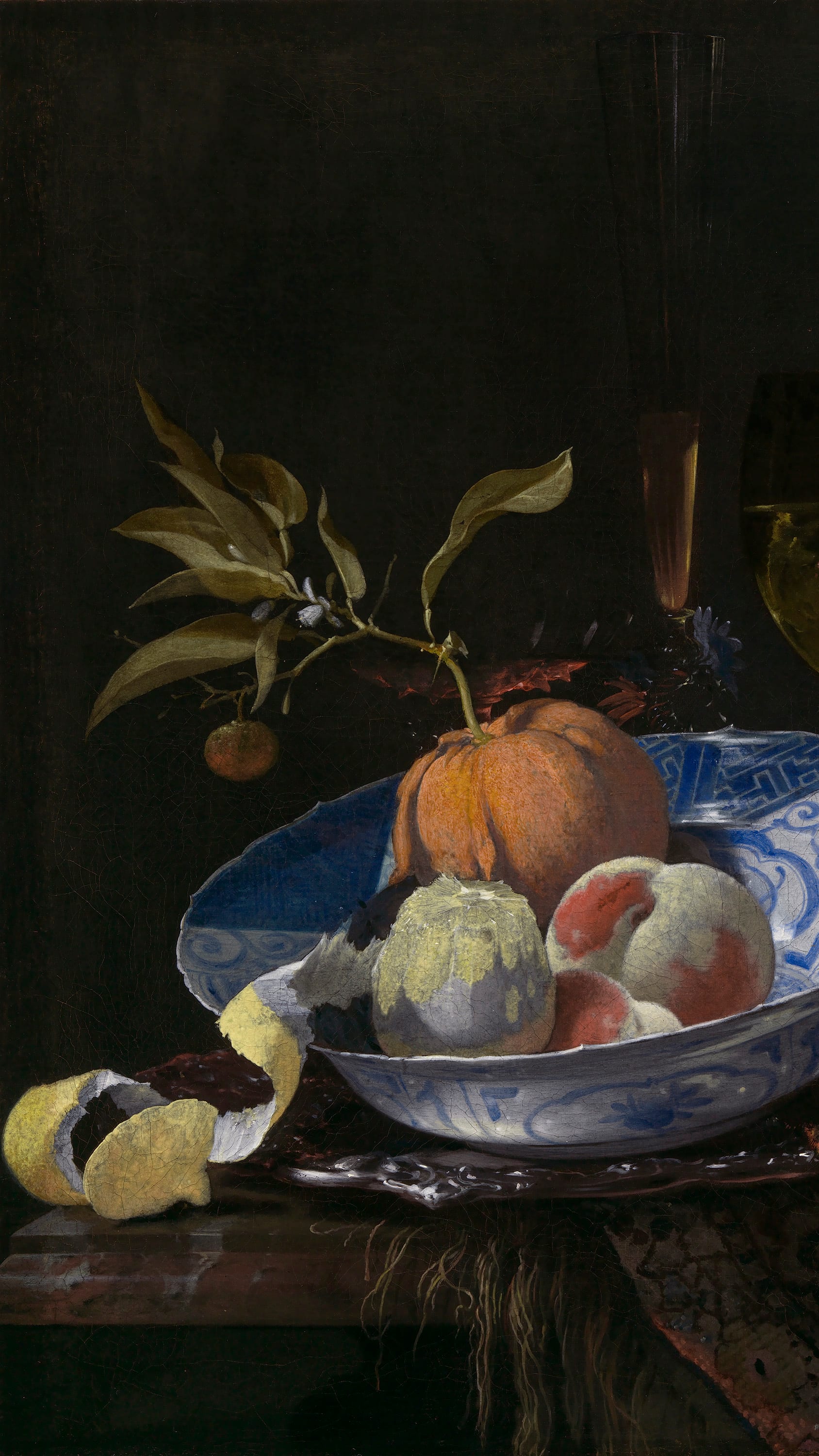 Dark academia vertical iPhone background from a painting: a blue-and-white porcelain bowl of peaches and a split pomegranate beside a wine glass, a lemon peeled in a long spiral draped over the table's edge