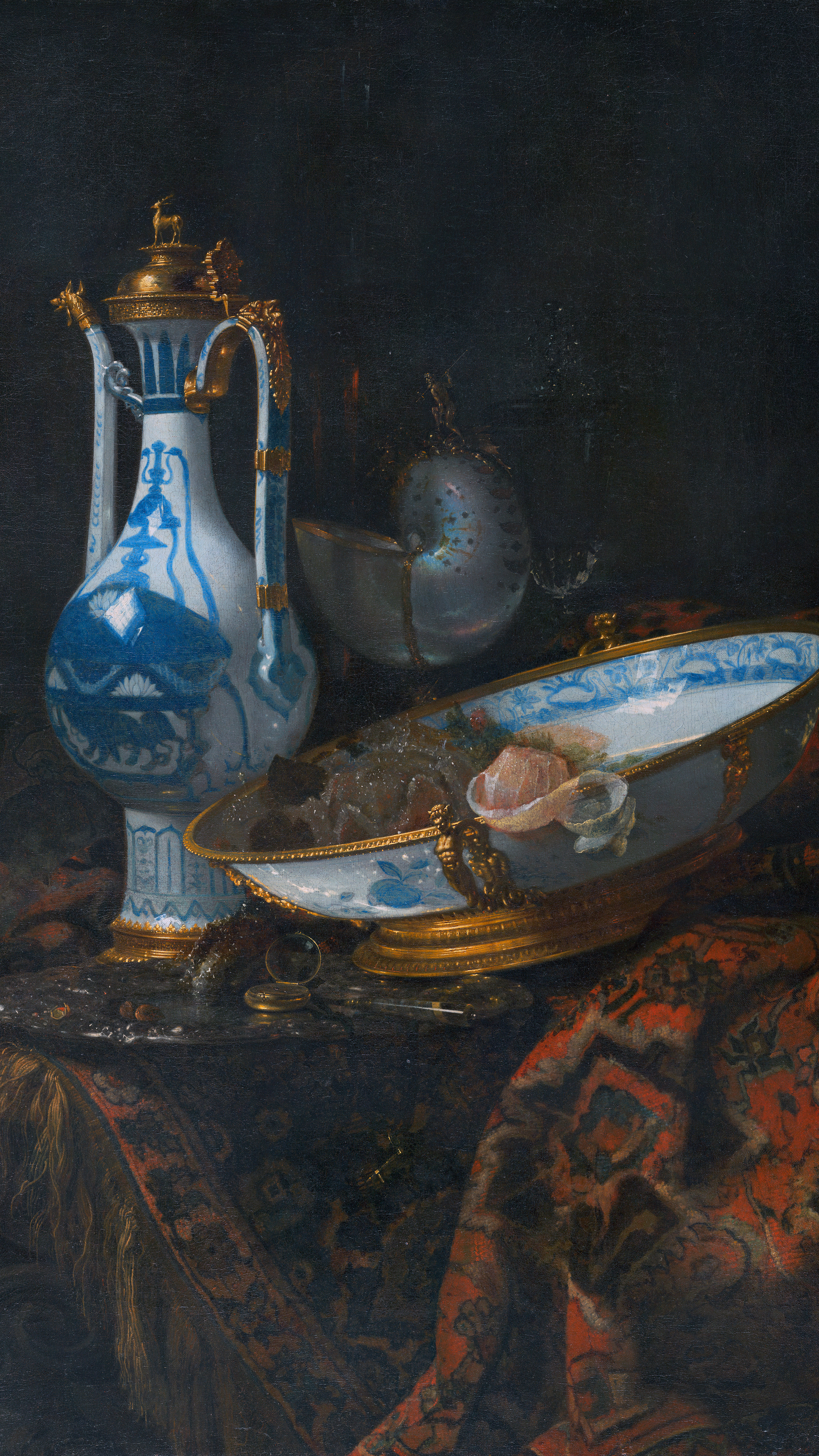 Dark moody vertical iPhone background from a painting: blue-and-white porcelain ewer beside an oval blue-and-white dish holding fruit and a pink nautilus shell, gilt mounts catching the light, a deep red patterned carpet draped below, near-black background