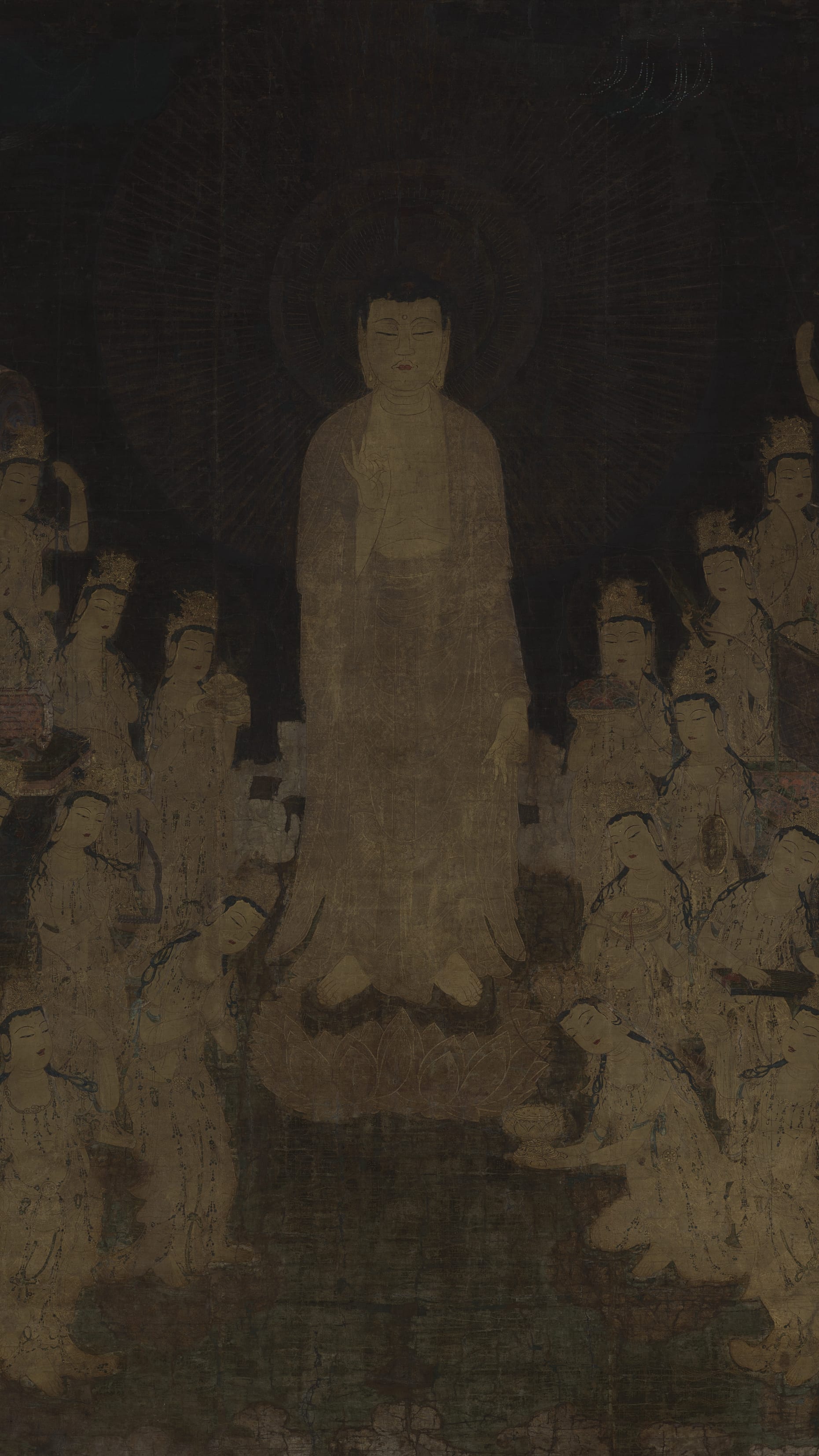 Dark moody vertical iPhone background from a Japanese painting: glowing standing Buddha descending amid a crowd of pale bodhisattvas, all in cream and gold on a near-black ground, ethereal and luminous