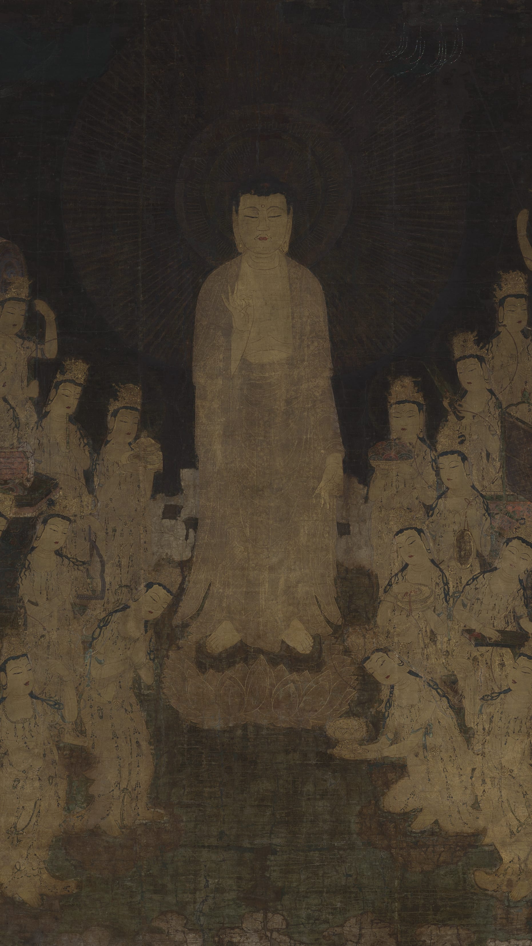 Dark moody vertical iPhone background from a Japanese painting: glowing standing Buddha descending amid a crowd of pale bodhisattvas, all in cream and gold on a near-black ground, ethereal and luminous