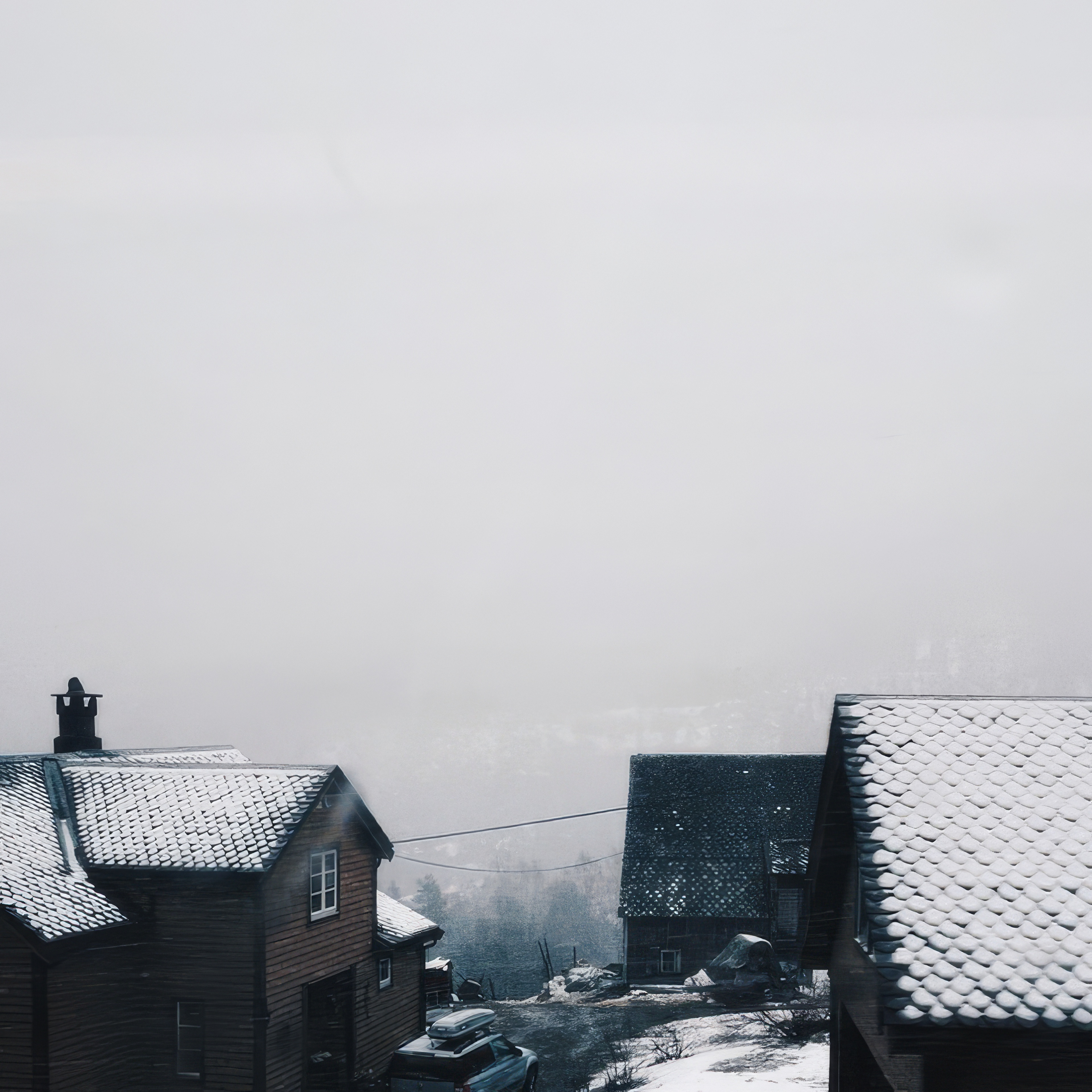 Phone wallpaper photo: snow falling over rooftops seen from above, chimneys and a lamppost in fog